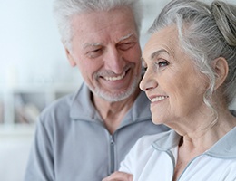 Older couple enjoying benefits of dental implants in Ann Arbor