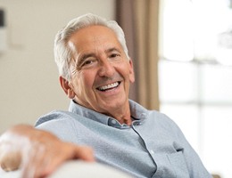 older man smiling after TENS therapy for T M J dysfunction
