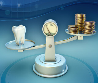 tooth and coins on a balance scale