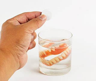 Dentures soaking in a solution