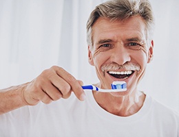 Man with dentures holding a toothbrush