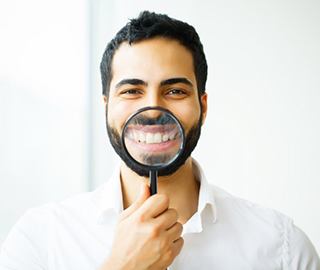 man showing off smile after dental bonding in Ann Arbor
