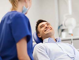 Man smiling at his emergency dentist in Ann Arbor