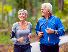 Older couple with dental implants in Ann Arbor jogging