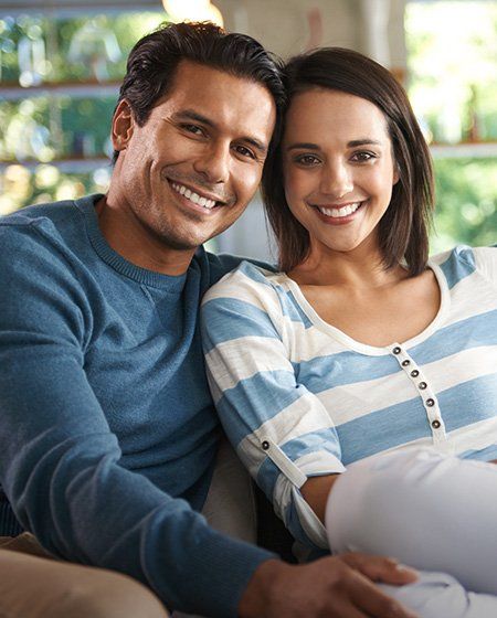 Young man and woman sitting together indoors