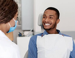 Man smiling at dentist during his dental checkup
