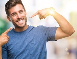 Man pointing to his smile with Invisalign