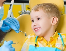 Smiling little boy in dental chair for children's dentistry