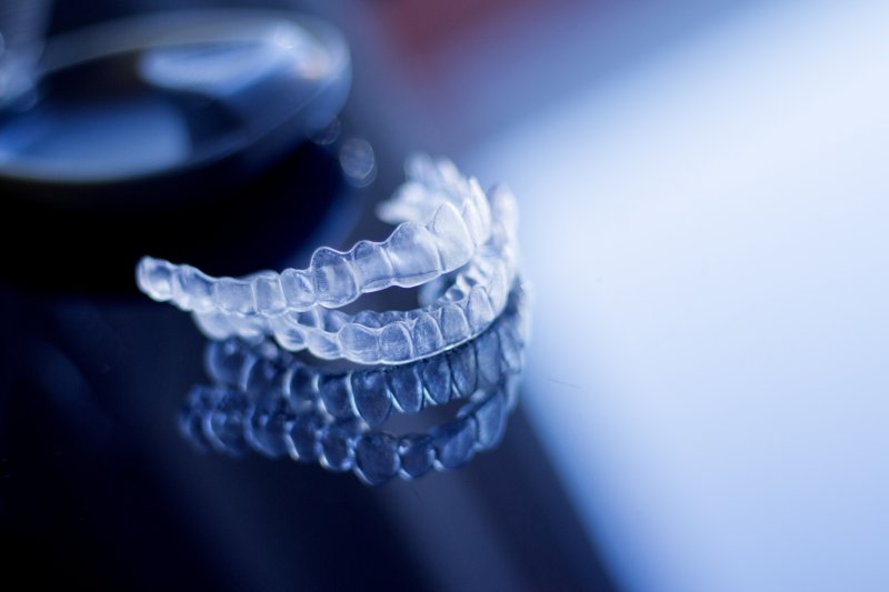 Invisalign aligners on a reflective table