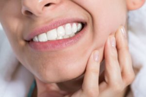 Woman with dental pain from bruxism